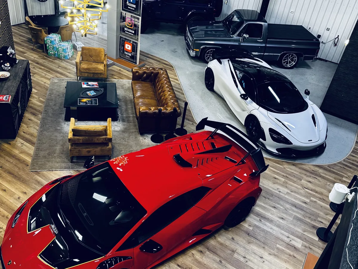 Overhead view of the ReCar showroom floor with sports cars, a classic pickup and the customer lounge